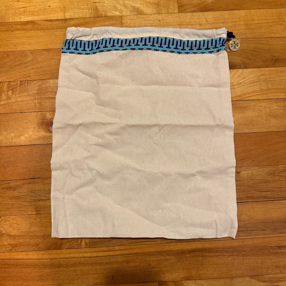 Tory Burch dust bag. New condition, emblem charm still has plastic on it.